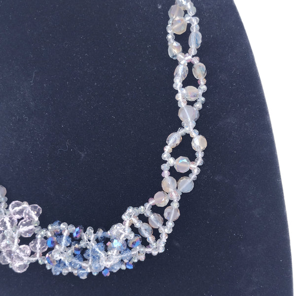 Close-up of a beaded necklace on a dark background