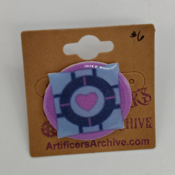 a grey square with a pink heart on a pink background