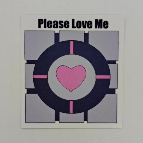 Image of a companion cube and the words 'please love me.'