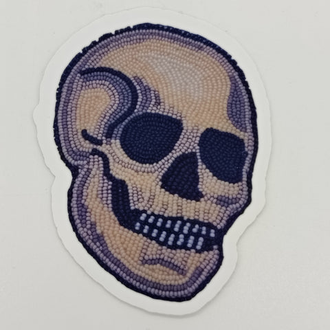 A sticker made from a photo of a beaded skull