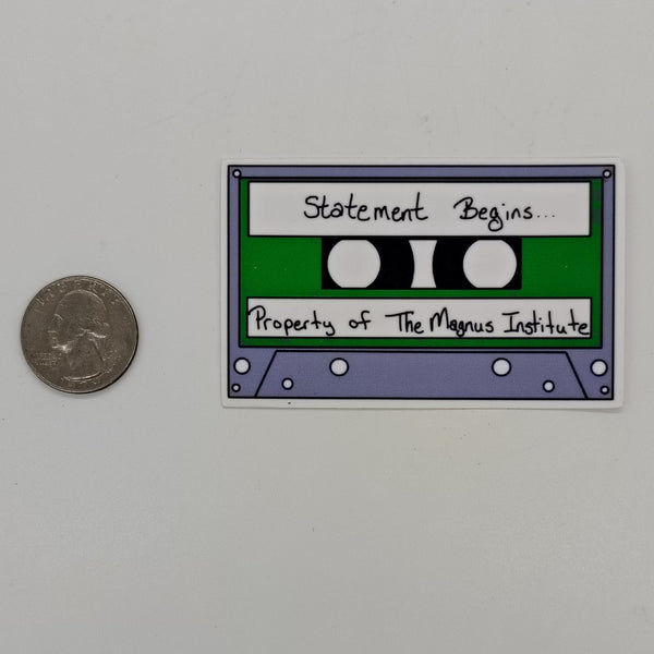 A sticker of a cassette tape with the words 'statement begins' and 'property of the magnus archives.'