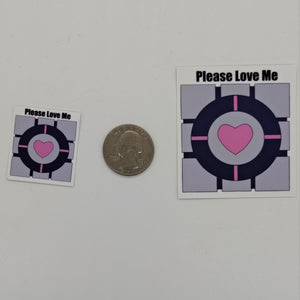 Image of a two companion cube stickers and the words 'please love me.'