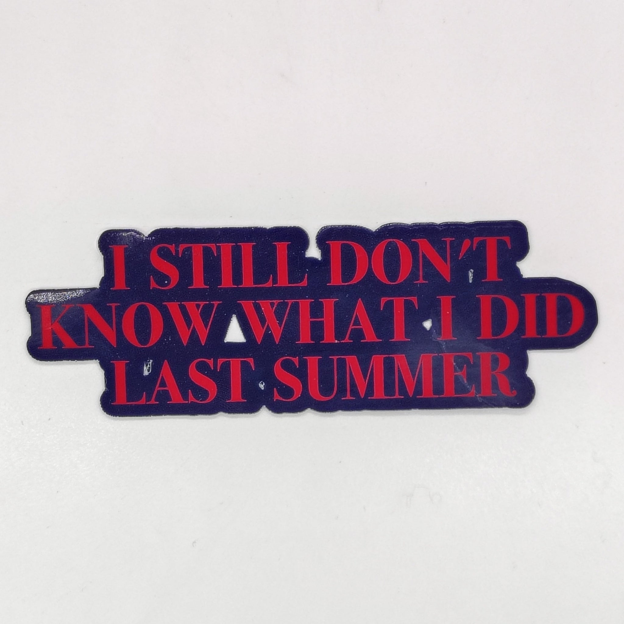 a sticker that says 'i still don't know what i did last summer' in red text on a black background