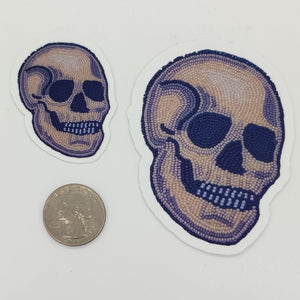 A sticker made from a photo of a beaded skull